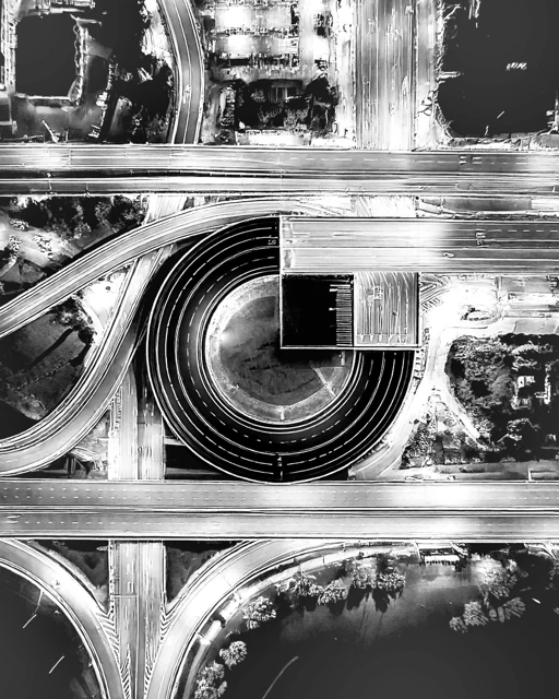 An aerial road and running-track composition forming the Gate symbol.