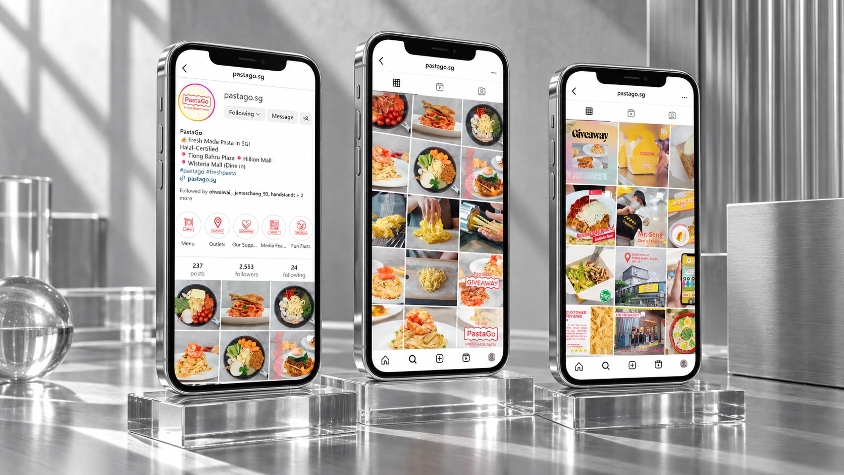 Three phones presenting PastaGo social content on glass stands in strong natural daylight.